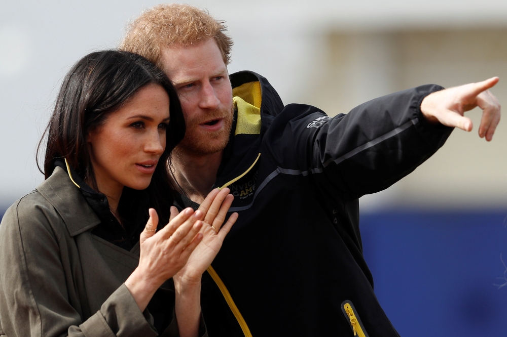 Britain's Prince Harry, Patron of the Invictus Games Foundation, and Meghan Markle watch athletes at the team trials for the Invictus Games Sydney 2018 at the University of Bath Sports Training Village in Bath, Britain, April 6, 2018. Reuters/Peter Nichol