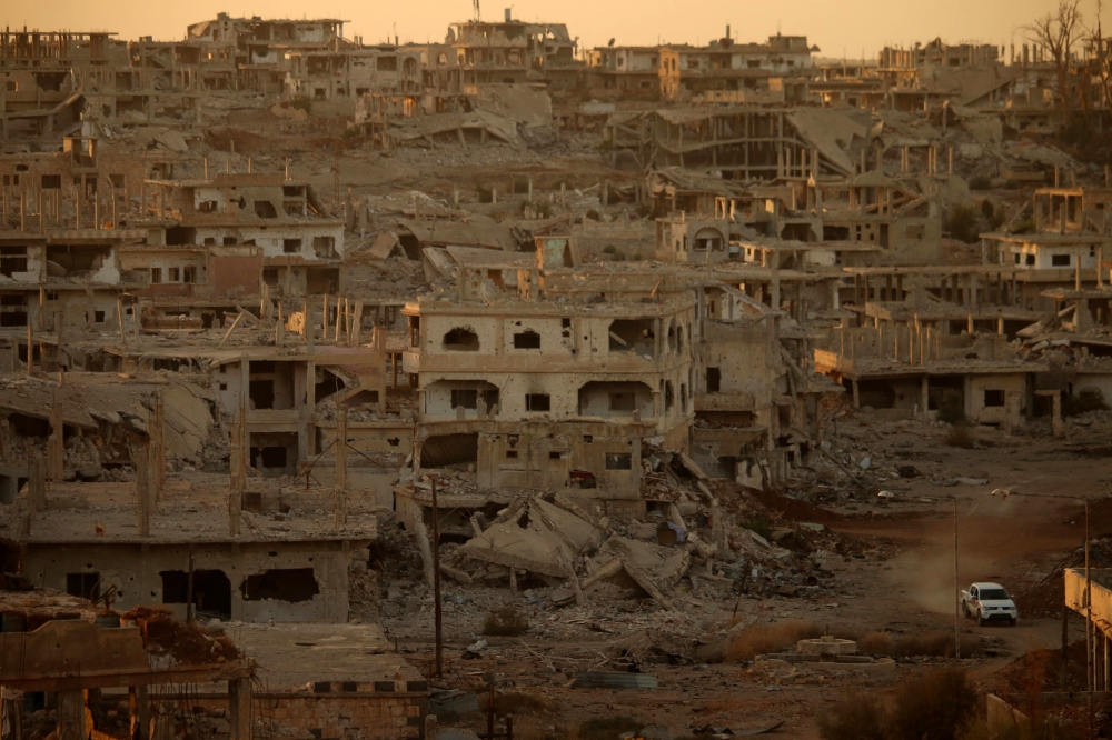 (FILES) In this file photo taken on November 16, 2017 a truck drives through a damaged street in a rebel-held area of the southern Syrian city of Daraa. AFP / Mohamad Abazeed 