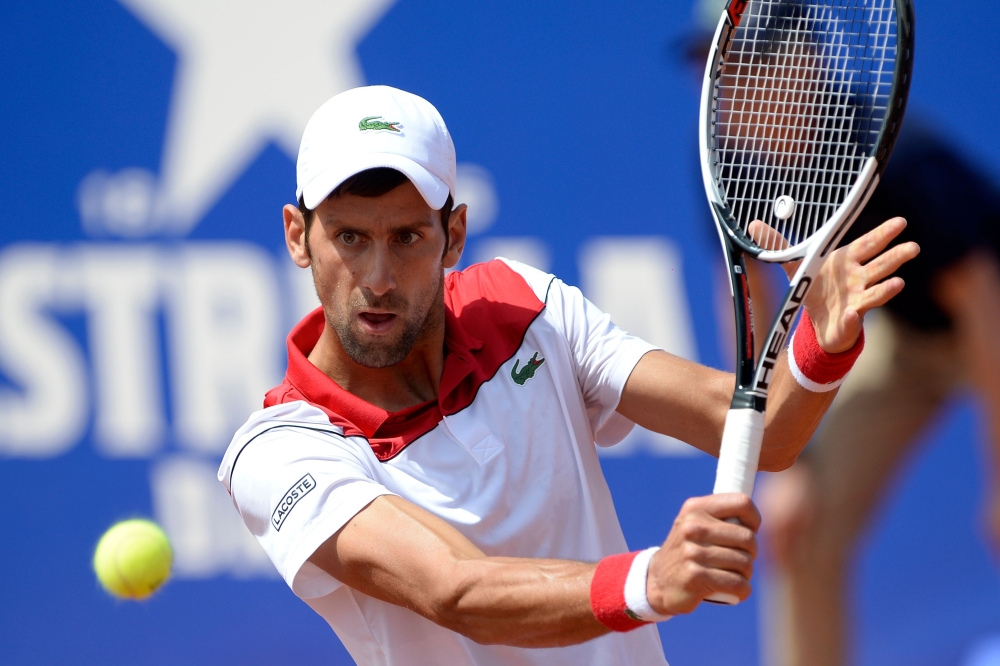 Serbia's Novak Djokovic returns the ball to Slovakia's Martin Klizan during their Barcelona Open ATP tournament tennis match in Barcelona on April 25, 2018. / AFP / Josep LAGO
