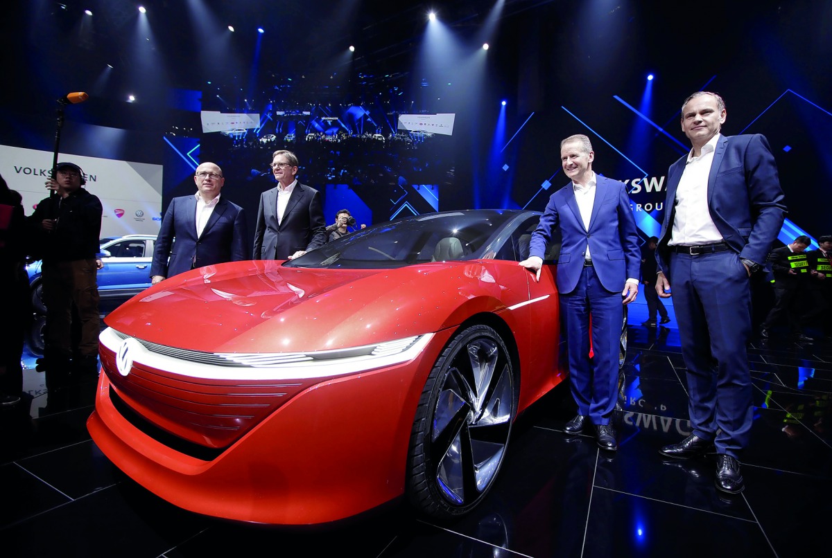 Herbert Diess, Volkswagen's new CEO, and another company leader pose for a photo next to a Volkswagen I.D. concept car at a media event ahead of the Beijing Auto Show in Beijing, China April 24, 2018. Reuters/Jason Lee
