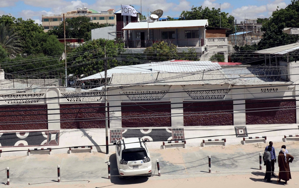 Unidentified people are seen outside the International Committee of the Red Cross (ICRC) compound in Madina District of Mogadishu, Somalia May 3, 2018. Reuters/Feisal Omar
