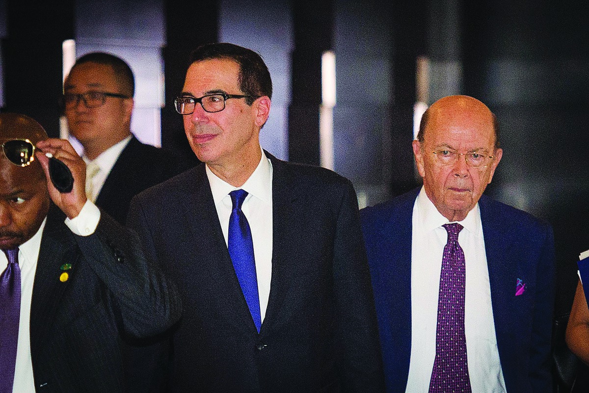 Commerce Secretary Wilbur Ross (R) walk through a hotel lobby as they head to the Diaoyutai State Guest House to meet Chinese officials for ongoing trade talks in Beijing on May 4, 2018. Top US and Chinese officials kicked off crucial trade talks on May 3
