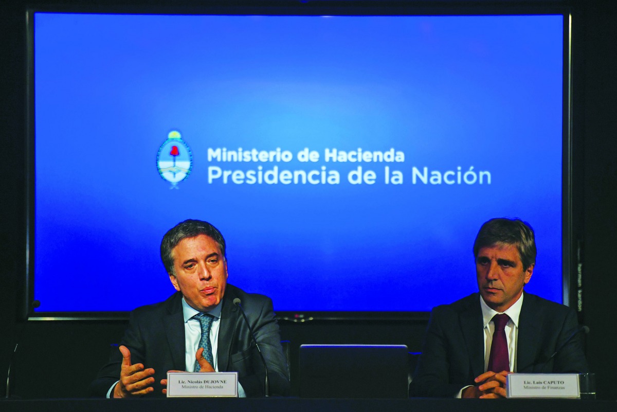 Argentina's Minister of the Treasury Nicolas Dujovne (L) and Argentina's Finance Minister Luis Caputo offer a press conference at the Ministry headquarters in Buenos Aires, on May 04, 2018.  AFP / Eitan Abramovich