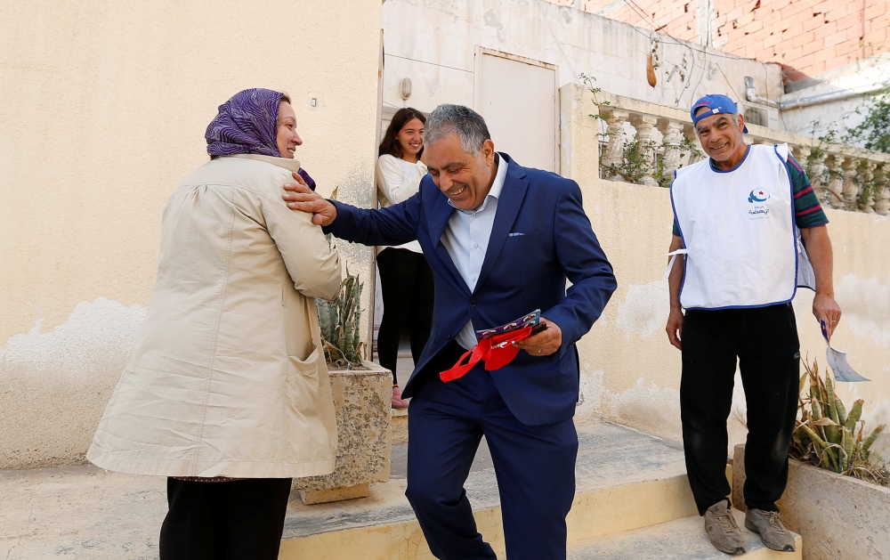 Simon Salama, a Tunisian Jew and 52-year old candidate from the Islamist Ennahda Party in the municipal elections, distributes leaflets in Monastir, Tunisia May 3, 2018. Picture taken May 3, 2018. REUTERS/Zoubeir Souissi
