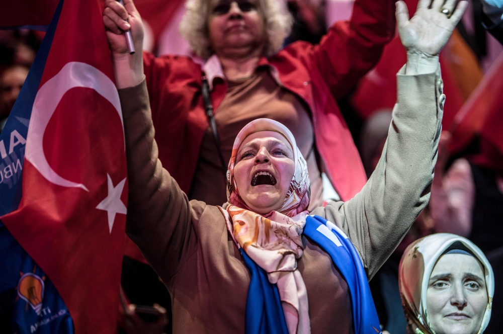 A supporter of the Turkish President cheers as she waits for the start of his speech in Istanbul, on May 6, 2018. AFP / Bulent Kilic