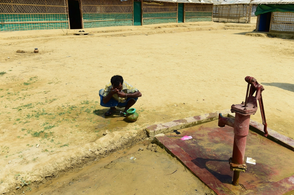 This photo taken on May 10, 2018 shows a Rohingya man preparing to make an offering for afternoon prayers at a refugee camp in Ukhia, Cox's Bazar. AFP / Munir Uz Zaman