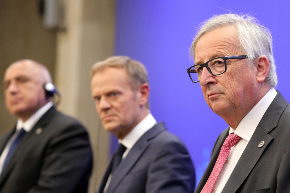 European Commission President Jean-Claude Juncker (R) reacts, next to European Council President Donald Tusk (C) and Bulgarian Prime Minister Boyko Borisov (L), during a joint press conference during an EU-Western Balkans Summit in Sofia on May 17, 2018. 