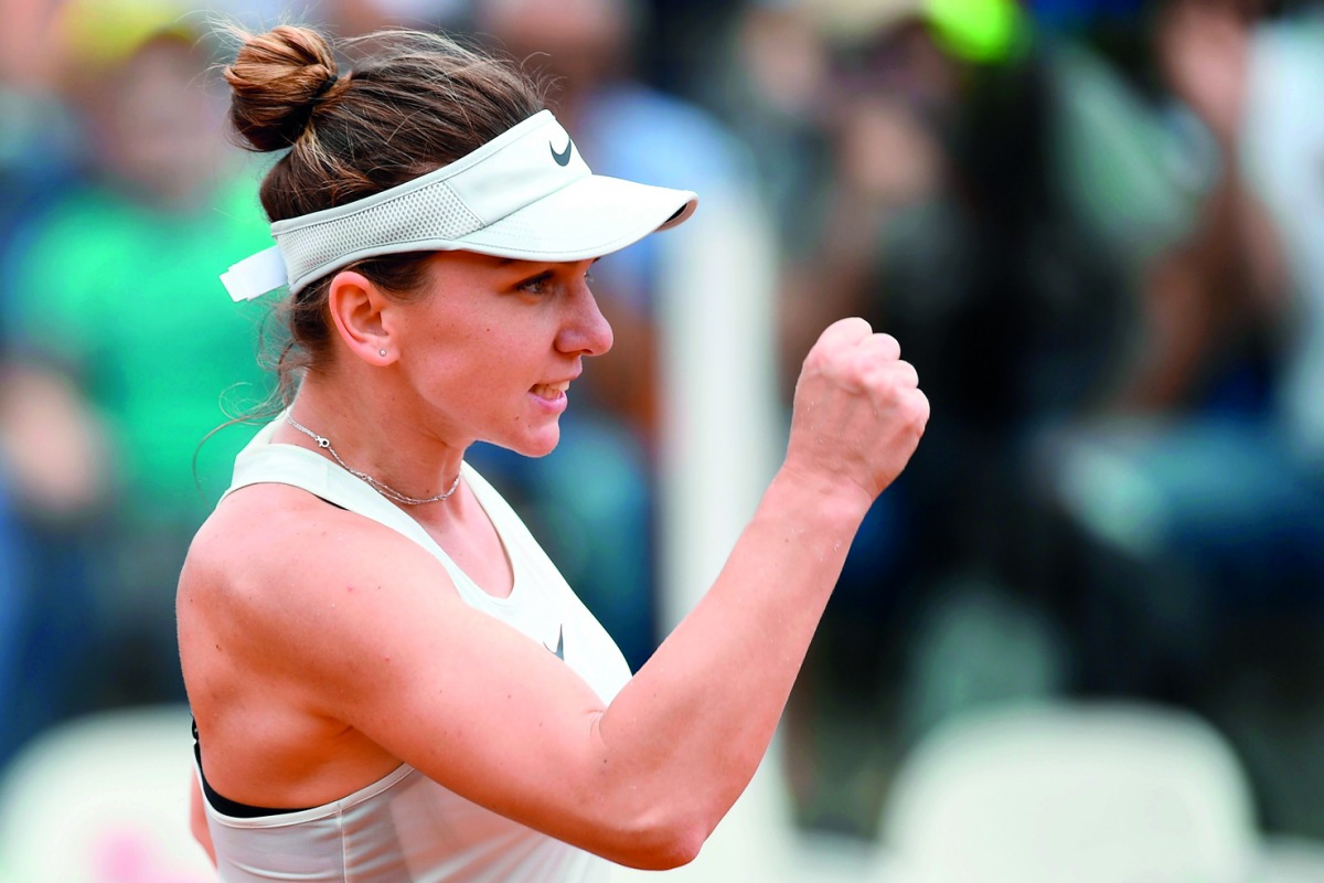 Romania's Simona Halep celebrates after winning her match against Japan's Naomi Osaka at Rome's WTA Tennis Open tournament at the Foro Italico, on May 16, 2018 in Rome.  AFP / Filippo Monteforte