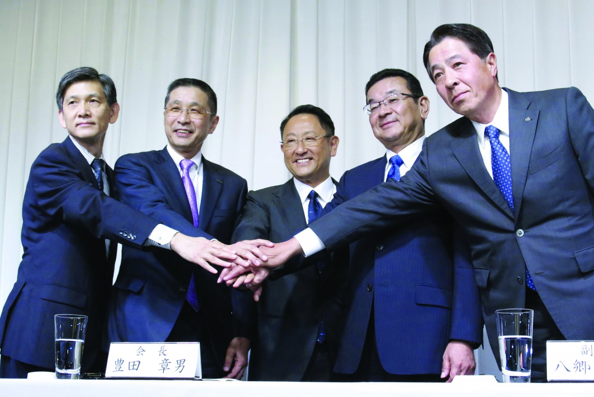 Newly appointed Chairman of Japan Automobile Manufacturers Association (JAMA) Akio Toyoda (C) who is also President of Toyota Motor Corp., and vice chairmen representing Japan's automobile manufacturers pose for a photograph after a news conference in Tok