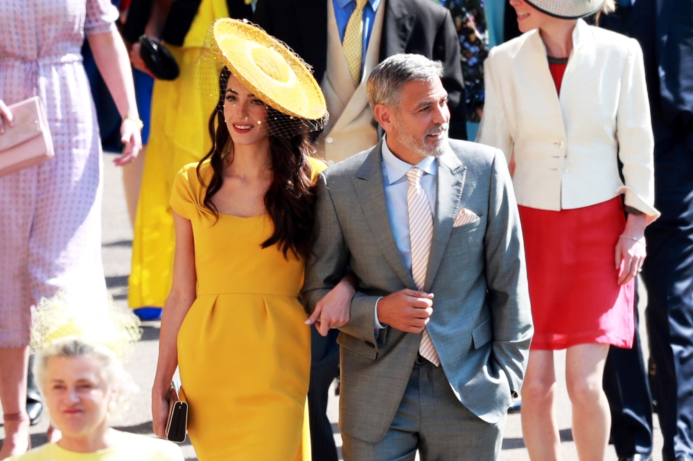 US actor George Clooney and his wife, British human rights barrister Amal Clooney arrive for the royal wedding ceremony of Britain's Prince Harry and Meghan Markle at St George's Chapel in Windsor Castle in Windsor, Britain, May 19, 2018. LAUREN HURLEY/Po