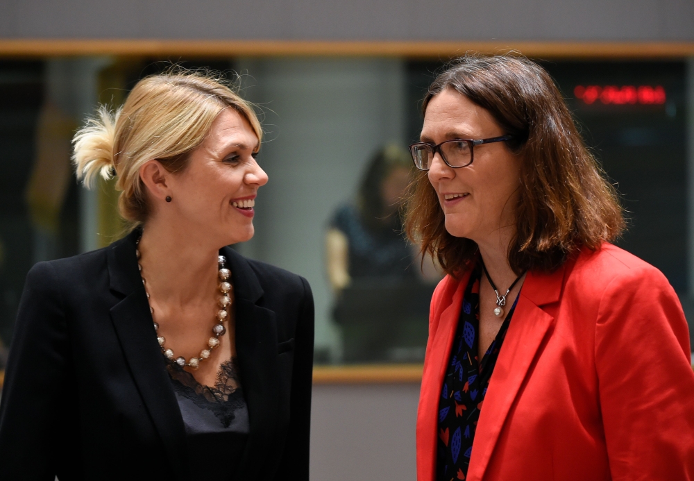 Estonian Minister of Foreign Trade Urve Palo (L) talks with EU Commissioner of Trade Cecilia Malmstrom (R) during a Foreign Affairs Trade Minister's meeting at the EU headquarters in Brussels on May 22, 2018. / AFP / JOHN THYS