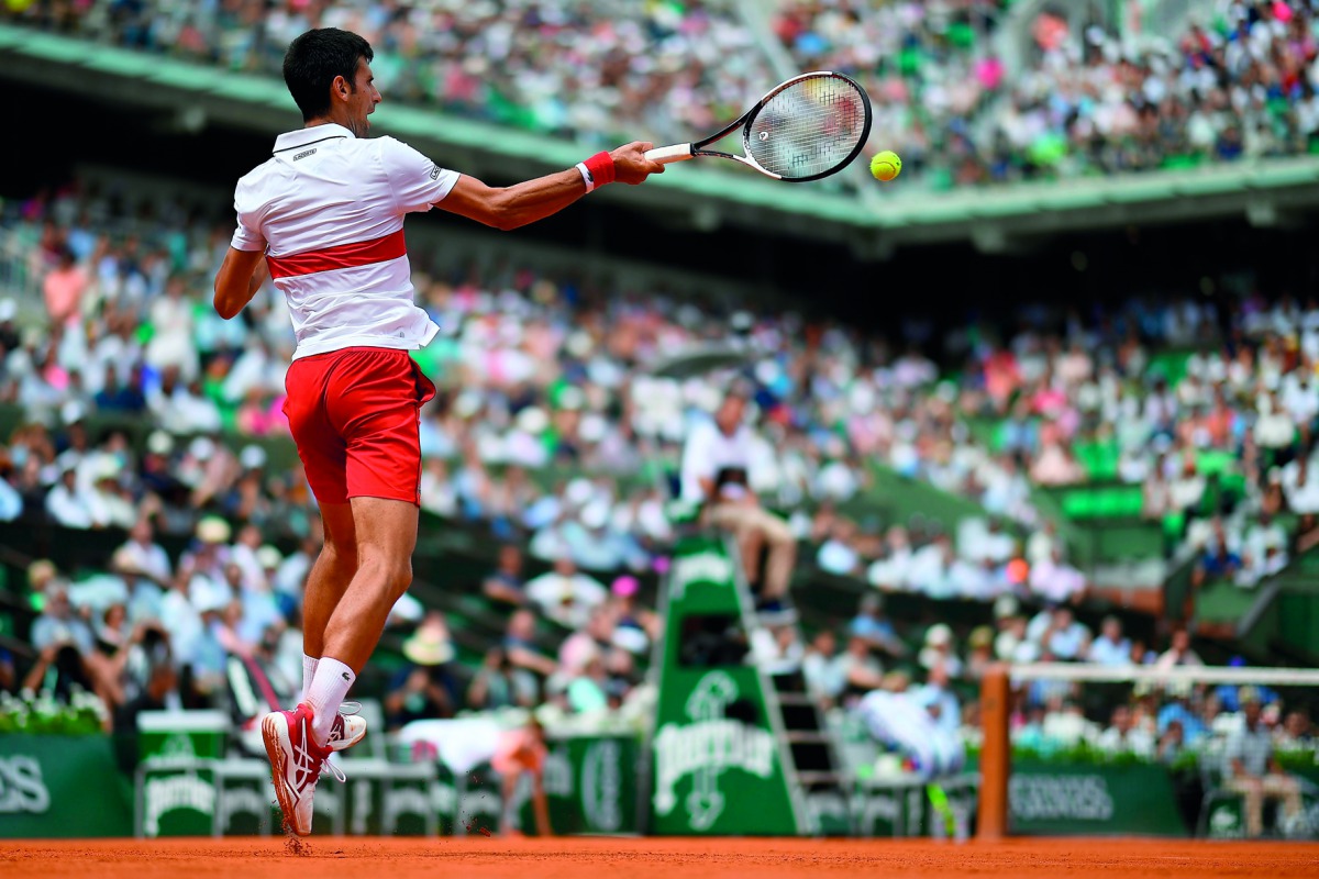 Serbia's Novak Djokovic plays a return to Brazil's Rogerio Dutra Silva during their men's singles first round match on day two of The Roland Garros 2018 French Open tennis tournament in Paris on May 28, 2018. AFP / Christophe Simon