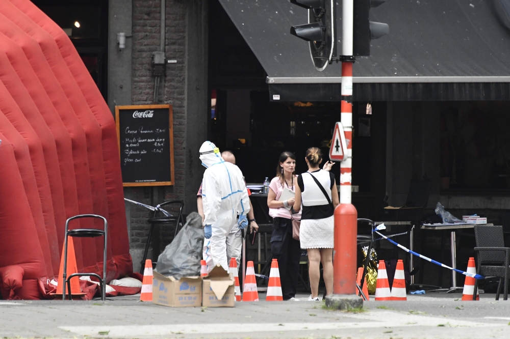 Forensic investigators work at the scene where a gunman shot dead two police officers and a bystander on the Boulevard d'Avroy in the eastern Belgian city of Liege, on May 29, 2018. Belgium OUT / AFP / Belga / ERIC LALMAND