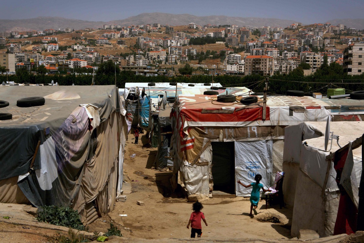 Syrian children play in a makeshift refugee camp on the outskirts of the town of Zahle in Bekaa Valley,  Lebanon,  on June 20, 2016.  AFP / Patrick Baz