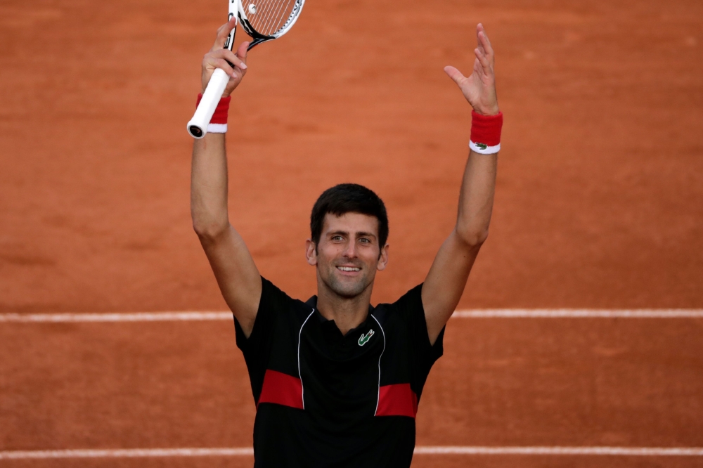 Serbia's Novak Djokovic celebrates after victory over Spain's Fernando Verdasco during their men's singles fourth round match on day eight of The Roland Garros 2018 French Open tennis tournament in Paris on June 3, 2018. / AFP / Thomas SAMSON
