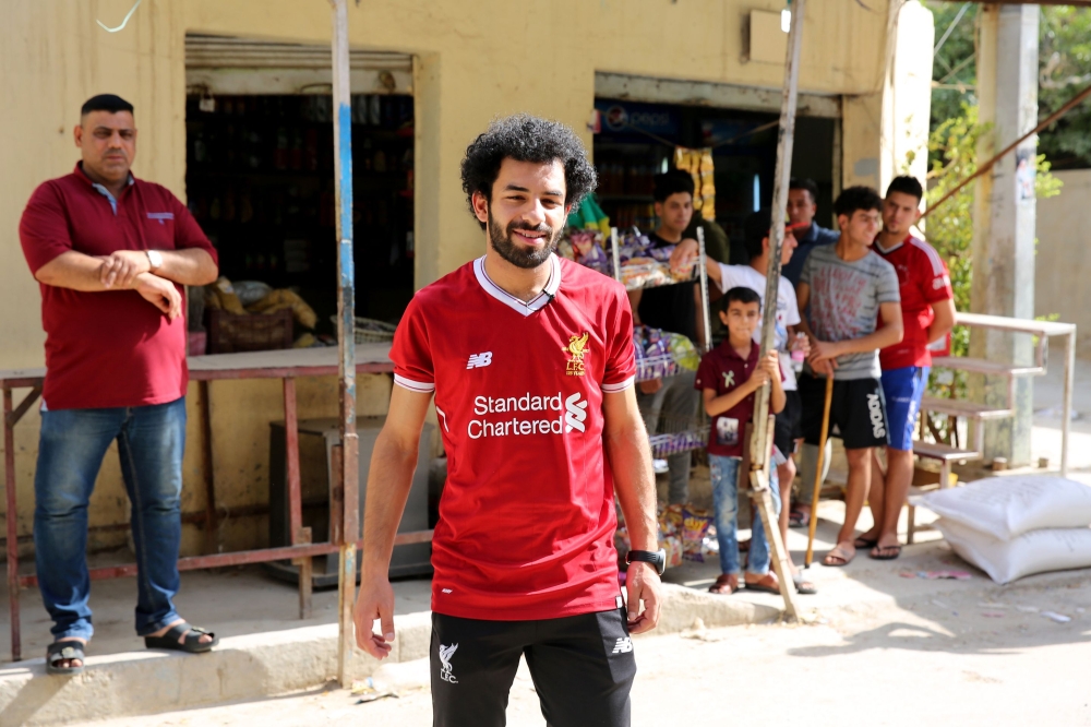 Iraqi footballer Hussein Ali, who plays for the Iraqi Al-Zawraa FC and is a lookalike of Liverpool's Egyptian forward Mohamed Salah, poses for pictures in the capital Baghdad, on June 4, 2018.  AFP / Sabah Arar