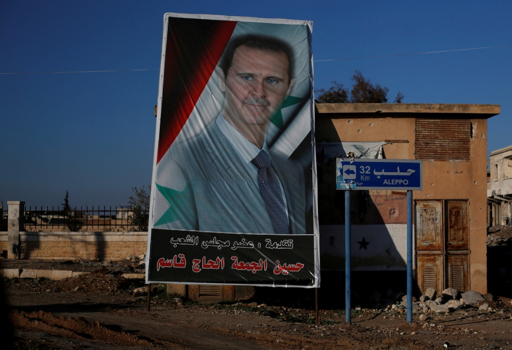 (FILE PHOTO) A picture of Syria's President Bashar al-Assad is seen in Ramouseh, a government-controlled area of Aleppo, Syria December 8, 2016. REUTERS/Omar Sanadiki
