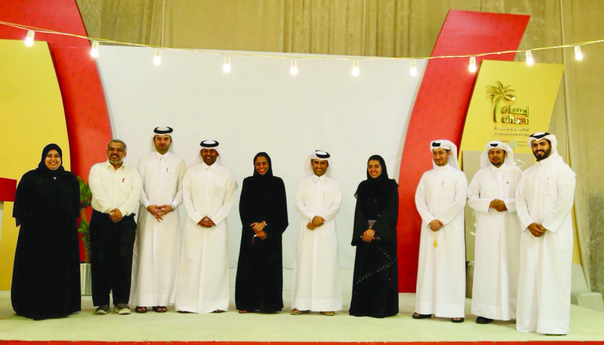 The officials of Ooredoo and Ehsan pose during the visit.