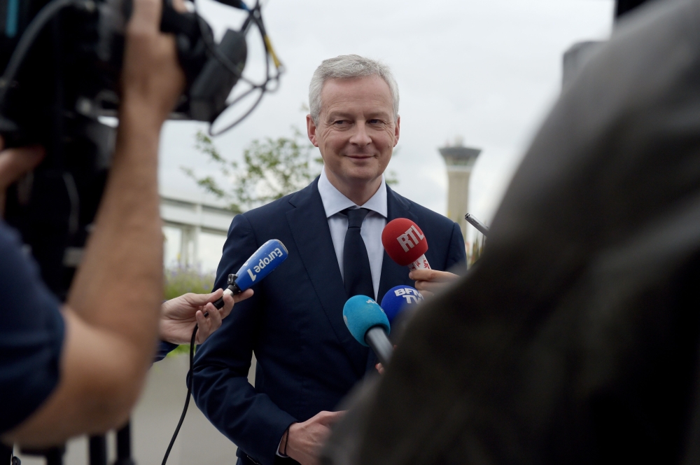 French Finance Minister Bruno Le Maire talks to the press on June 13, 2018 following a press conference at the ADP headquarters in Tremblay-en-France near Roissy airport.  AFP / ERIC PIERMONT
