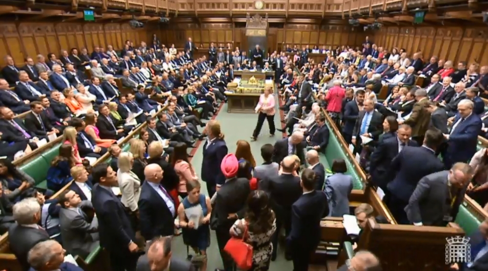 A video grab from footage broadcast by the UK Parliament's Parliamentary Recording Unit (PRU) shows members of the Scottish National Party (SNP) walking out during Prime Minister's Questions (PMQs) in the House of Commons in London on June 13, 2018. (AFP 