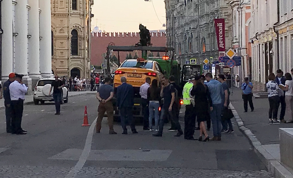 A damaged taxi, which ran into a crowd of people, is evacuated in central Moscow, Russia June 16, 2018. (REUTERS/Jack Stubbs)