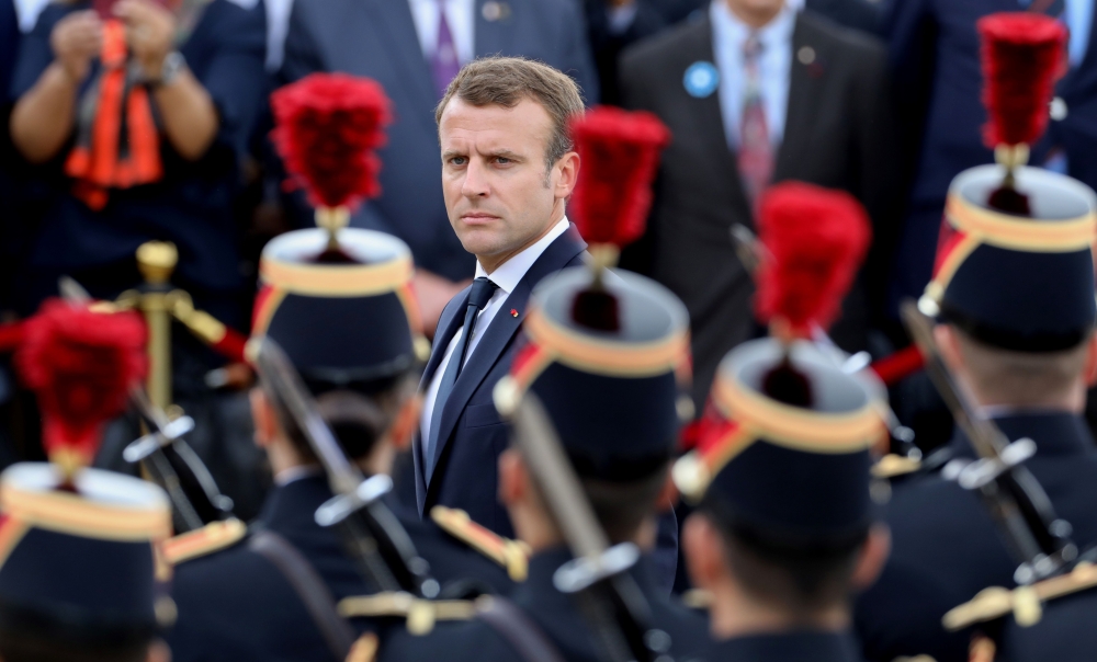 French President Emmanuel Macron reviews a troop of French army soldiers during a ceremony, commemorating General Charles De Gaulle's June 1940 appeal for French resistance against Nazi Germany, at The Mont Valerien National Memorial in Suresnes on the ou
