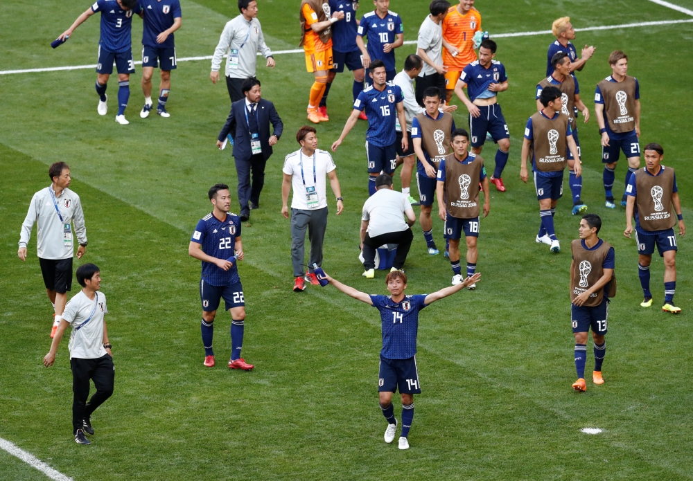 Japan players celebrate after the match, June 19, 2018. REUTERS/Damir Sagolj