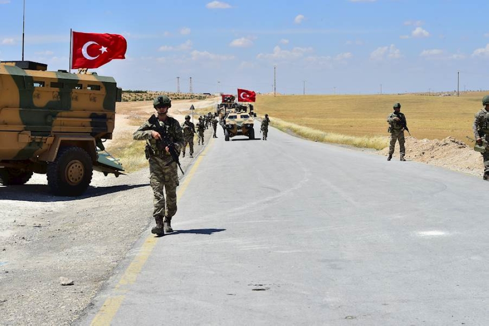 Armoured vehicles and soldiers of Turkish Armed Forces start to patrol between northern Syrian city of Manbij and Turkey's Operation Euphrates Shield area on June 18, 2018.   Anadolu Agency
