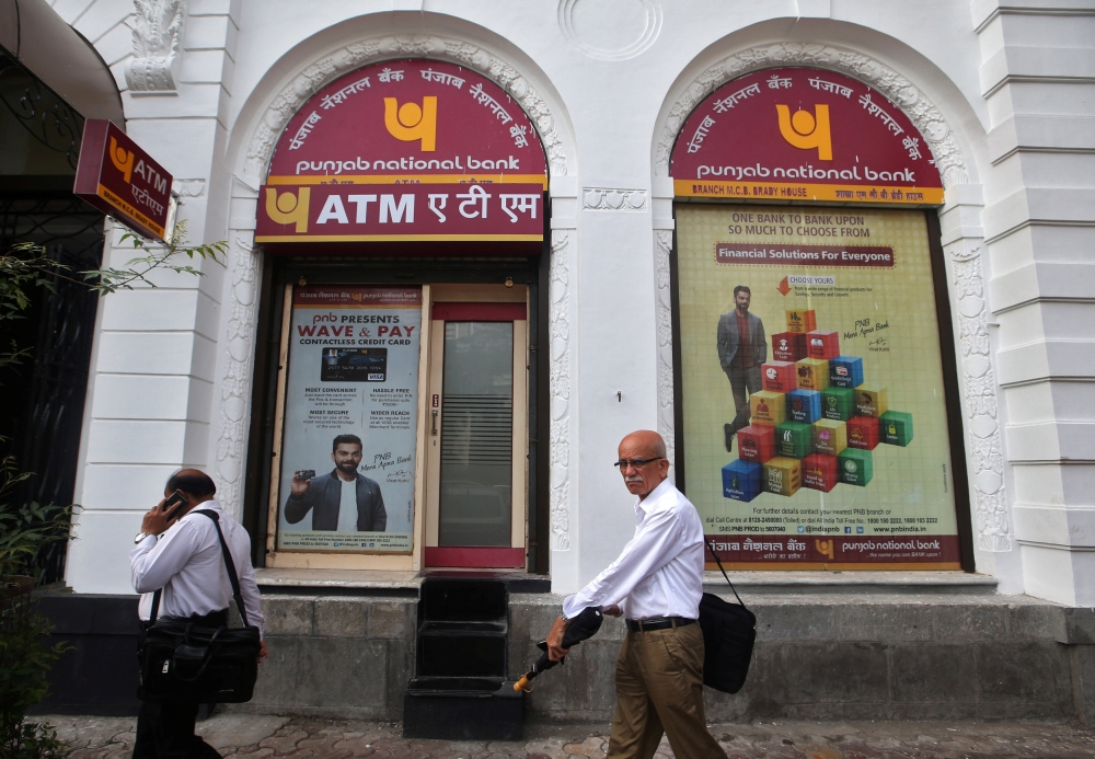 People walk past Punjab National Bank's Brady House branch in Mumbai, India June 14, 2018. REUTERS/Francis Mascarenhas