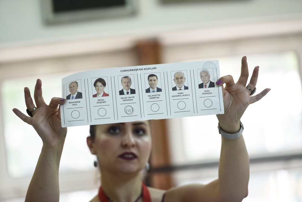 An election committee member shows a ballot displaying a vote for Recep Tayyip Erdogan, Turkish President and leader of the Justice and Development Party (AKP) at a polling station during the Turkish presidential and parliamentary elections in Istanbul on