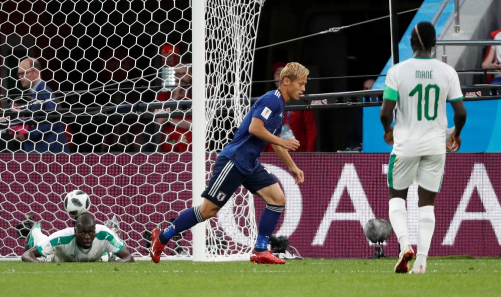 Japan's Keisuke Honda celebrates scoring their second goal REUTERS/Max Rossi