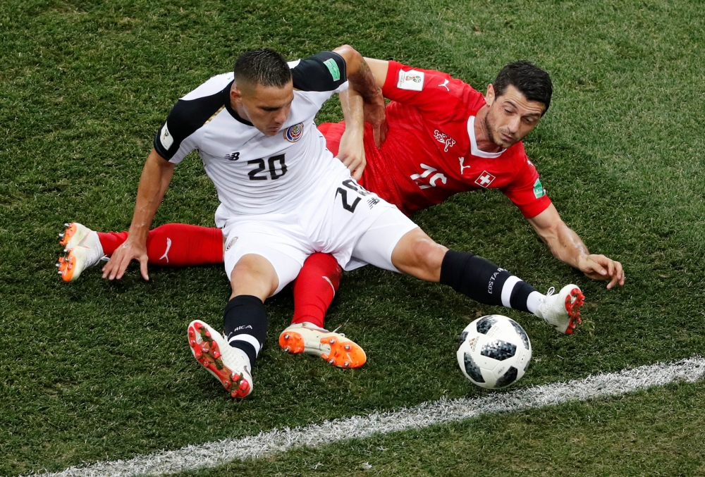Costa Rica's David Guzman in action with Switzerland's Blerim Dzemaili. Reuters/Carlos Barria