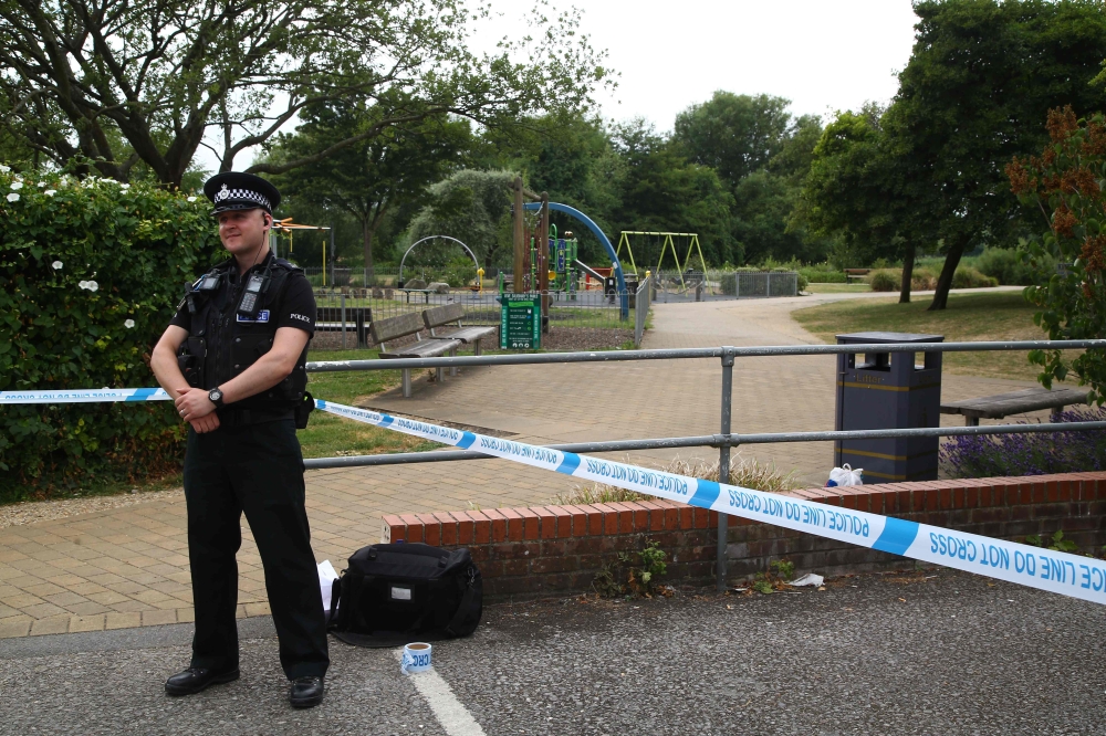 A police officer stands at a cordon at Queen Elizabeth Gardens in Salisbury, southern England, on July 4, 2018 believed to be cordoned off in relation to a major incident declared after two people were found unconcious at a residence in nearby Amesbury. A
