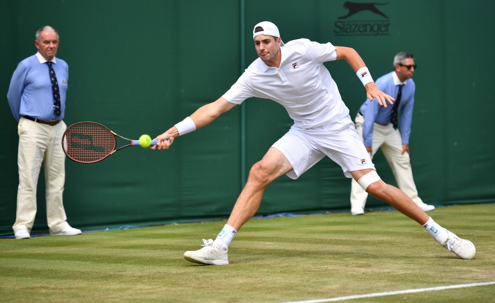 US player John Isner returns against Belgium's Ruben Bemelmans during their men's singles second round match on the fourth day of the 2018 Wimbledon Championships at The All England Lawn Tennis Club in Wimbledon, southwest London, on July 5, 2018. (AFP / 