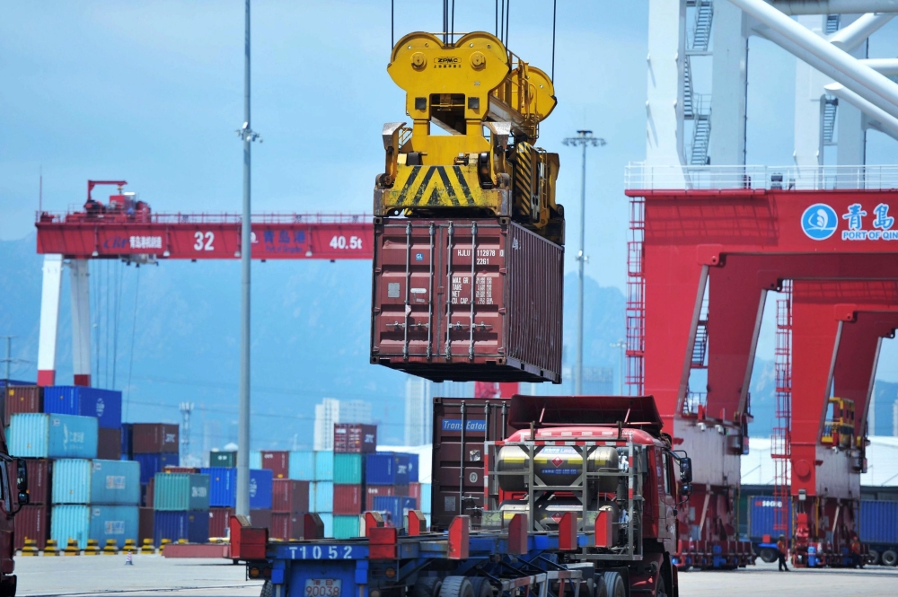 A container is transferred at a port in Qingdao in China's eastern Shandong province on July 6, 2018.  AFP