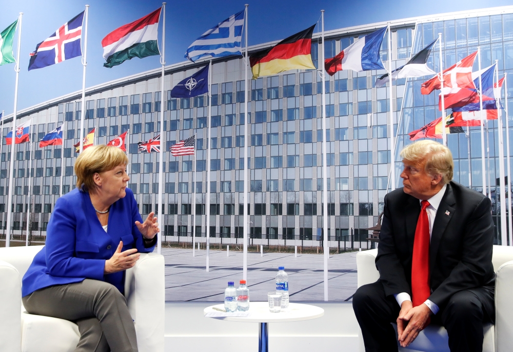 US President Donald Trump and German Chancellor Angela Merkel attend a bilateral meeting during the NATO Summit in Brussels, Belgium July 11, 2018. (REUTERS/Kevin Lamarque)