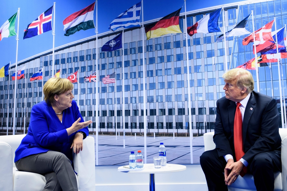 
German Chancellor Angela Merkel (L) and US President Donald Trump (R) make a statement to the press after a bilateral meeting on the sidelines of the NATO (North Atlantic Treaty Organization) summit at the NATO headquarters, in Brussels, on July 11, 201