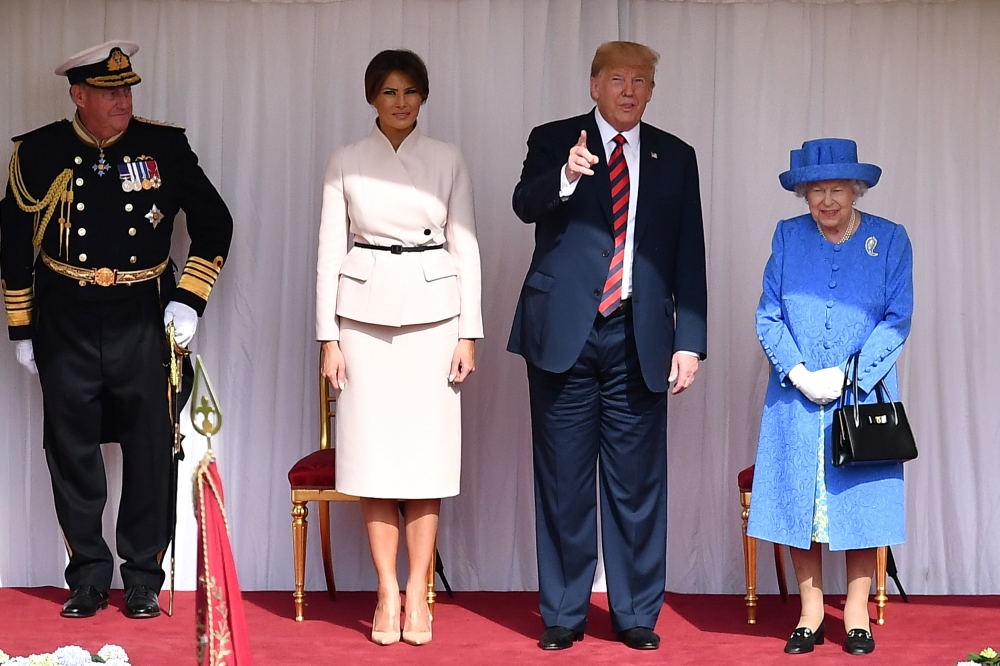 US President Donald Trump and First Lady Melania Trump stand with Britain's Queen Elizabeth on the dais in the Quadrangle at Windsor Castle, Windsor, Britain July 13, 2018. Ben Stansall/Pool via REUTERS
 