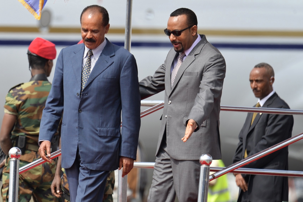 Eritrea president Issaias Afeworki (L) is welcomed upon arrival by Prime minister of Ethiopia Abiy Ahmed on July 14, 2018 at Addis Ababa Bole International Airport for his official visit to Ethiopia after more than twenty years in border conflict among th