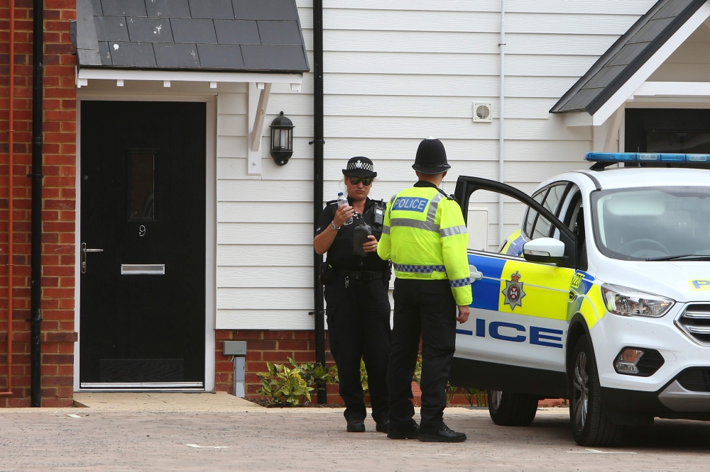 (FILES) In this file photo taken on July 4, 2018, a police officer stands guard outside Charlie Rowley's house in Amesbury, southern England, on July 4, 2018 where police reported a man and woman were found unconscious in circumstances that sparked a majo