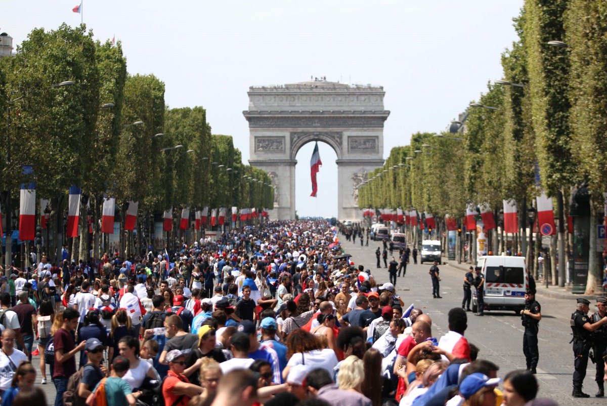 Crowds began converging early Monday on the Champs Elysees, the gathering point for all national celebrations, for a parade by the team atop an electric bus expected to start in the early evening.