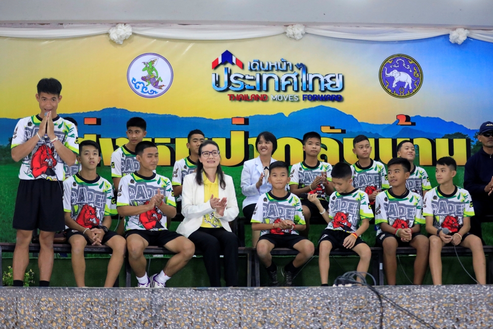 The 12 boys and their soccer coach who were rescued from a flooded cave arrive for a news conference in the northern province of Chiang Rai, Thailand, July 18, 2018. REUTERS/Soe Zeya Tun