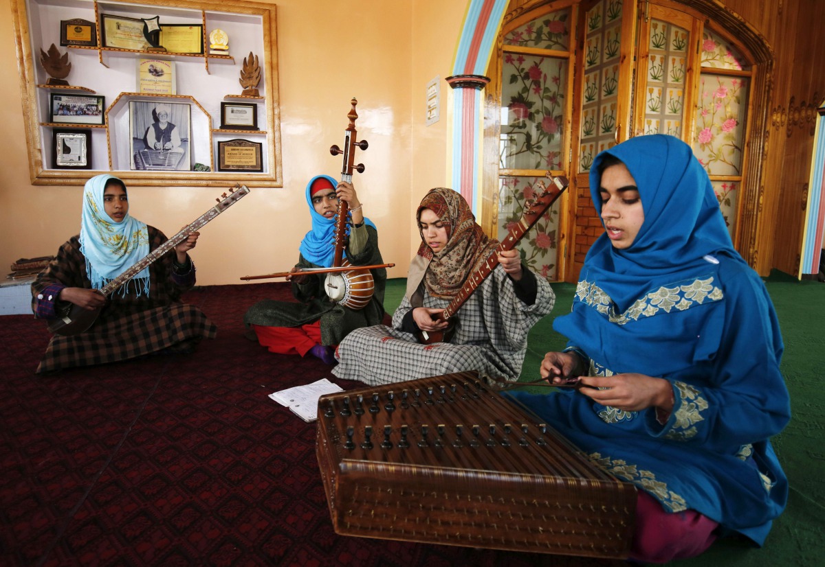 In this photograph taken on February 25, 2017 Kashmiri girls play instruments and sing Sufi music under the tutelage of music teacher Muhammad Yaqoob Sheikh on the outskirts of Srinagar (AFP) 