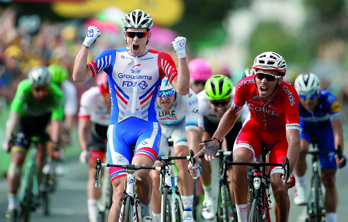 France's Arnaud Demare (L) celebrates as he crosses the finish line to win, ahead of France's Christophe Laporte (R) the 18th stage of the 105th edition of the Tour de France cycling race, on July 26, 2018 between Trie-sur-Baise and Pau, southwestern Fran