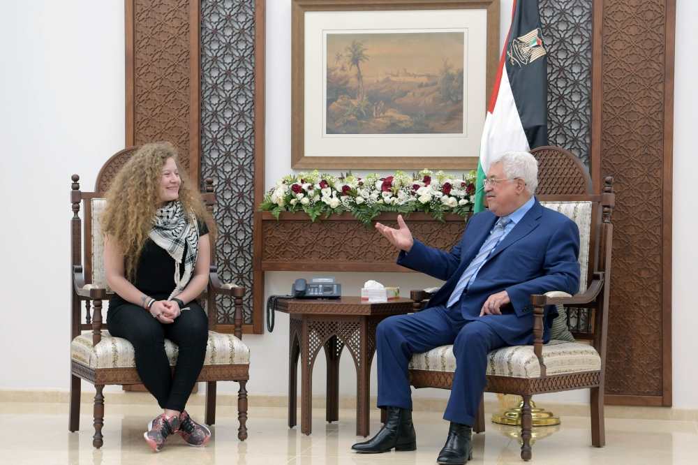 Palestinian President Mahmoud Abbas meets with Freed Palestinian teenager Ahed Tamimi after she was released from an Israeli prison, in Ramallah in the occupied West Bank July 29, 2018. (PPO/Handout via REUTERS)