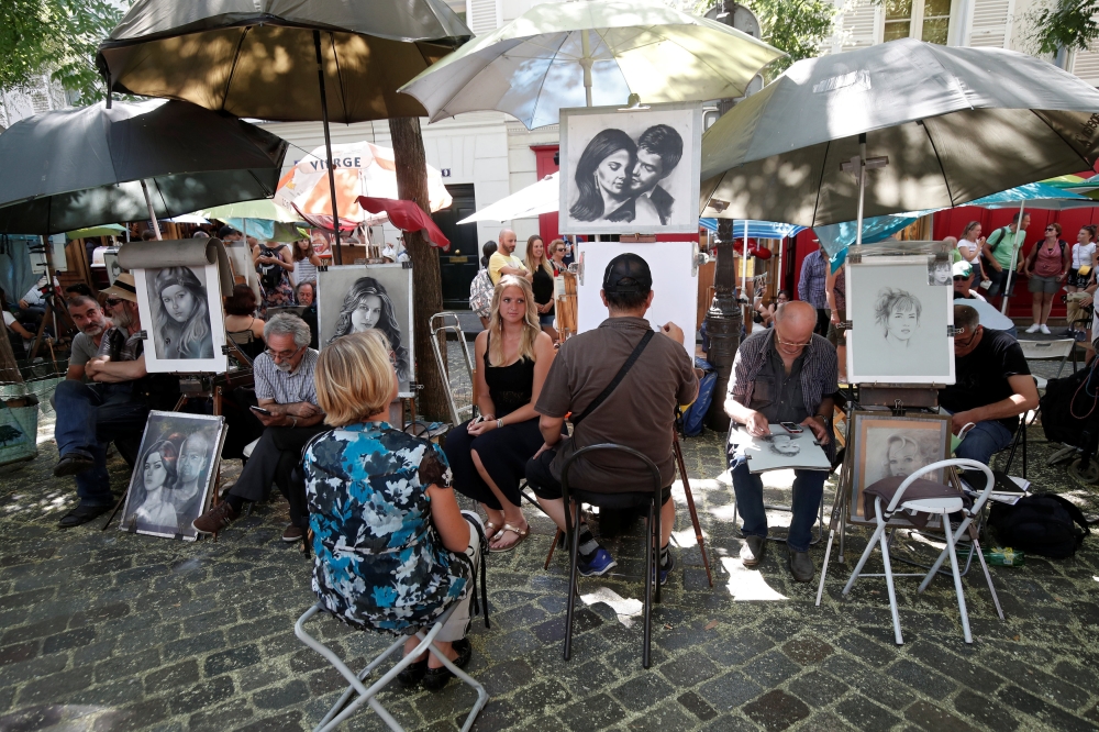 General view of artists who sketch portraits in the street on the 