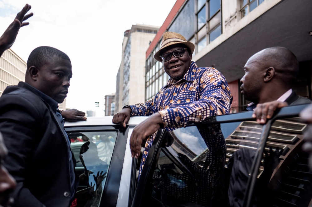Former Zimbabwean Finance Minister and MDC Alliance member Tendai Biti greets supporters outside the MDC Alliance's headquarters in Harare on July 31, 2018. AFP / Marco Longari
 