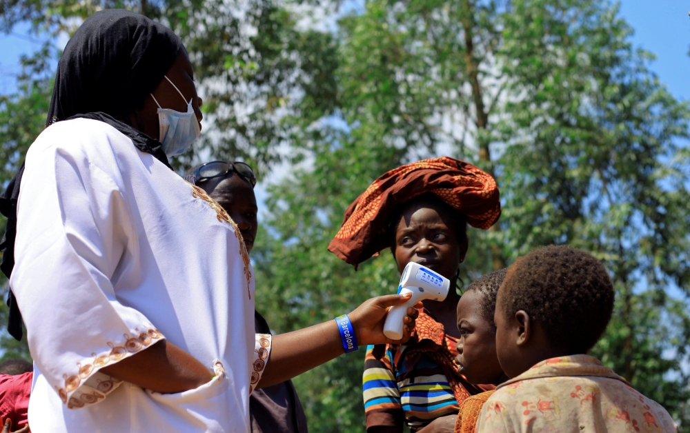 A Congolese health worker checks the temperature of a child before the launch of vaccination campaign against the deadly Ebola virus near Mangina village, near the town of Beni, in North Kivu province of the Democratic Republic of Congo, August 8, 2018. R