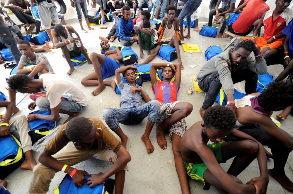 Migrants rest after being rescued by SOS Mediterranee organisation and Doctors Without Borders during a search and rescue (SAR) operation with the MV Aquarius rescue ship in the Mediterranean Sea, off the Libyan Coast, August 10, 2018. Reuters/Guglielmo M