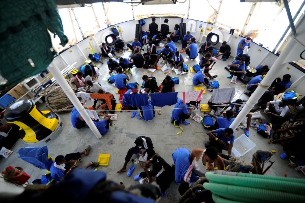 Migrants are seen on board the MV Aquarius, in the Mediterranean Sea, between Malta and Linosa, August 14, 2018. (REUTERS/Guglielmo Mangiapane)
